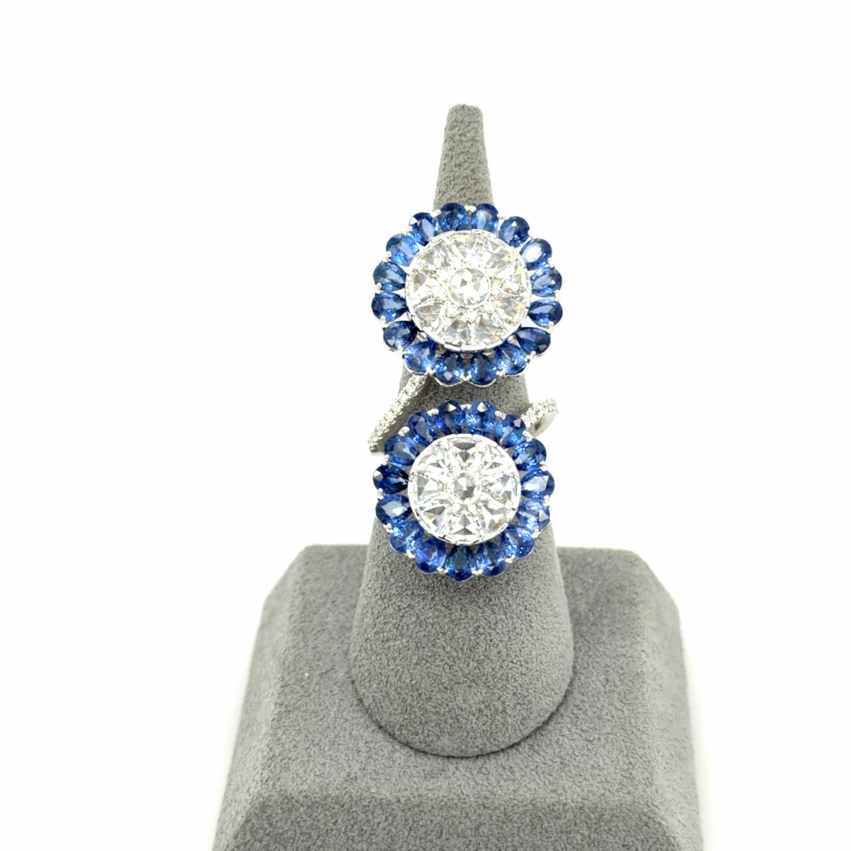 Sapphire and diamond double spinwheel ring in 18K white gold on a ring display