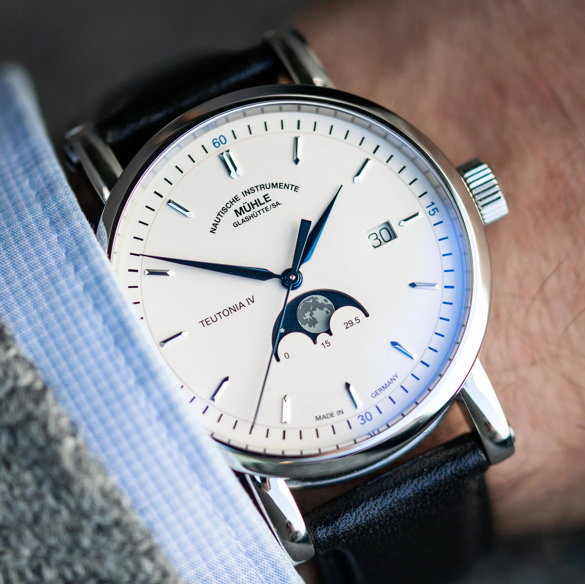 Mühle-Glashütte Teutonia IV Moonphase men's watch with white dial and blue hands, on the wrist