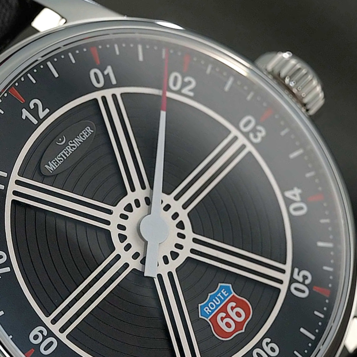 MeisterSinger Edition Route 66 dial close-up showing the silver-white spokes, concentric engraving and Route 66 emblem