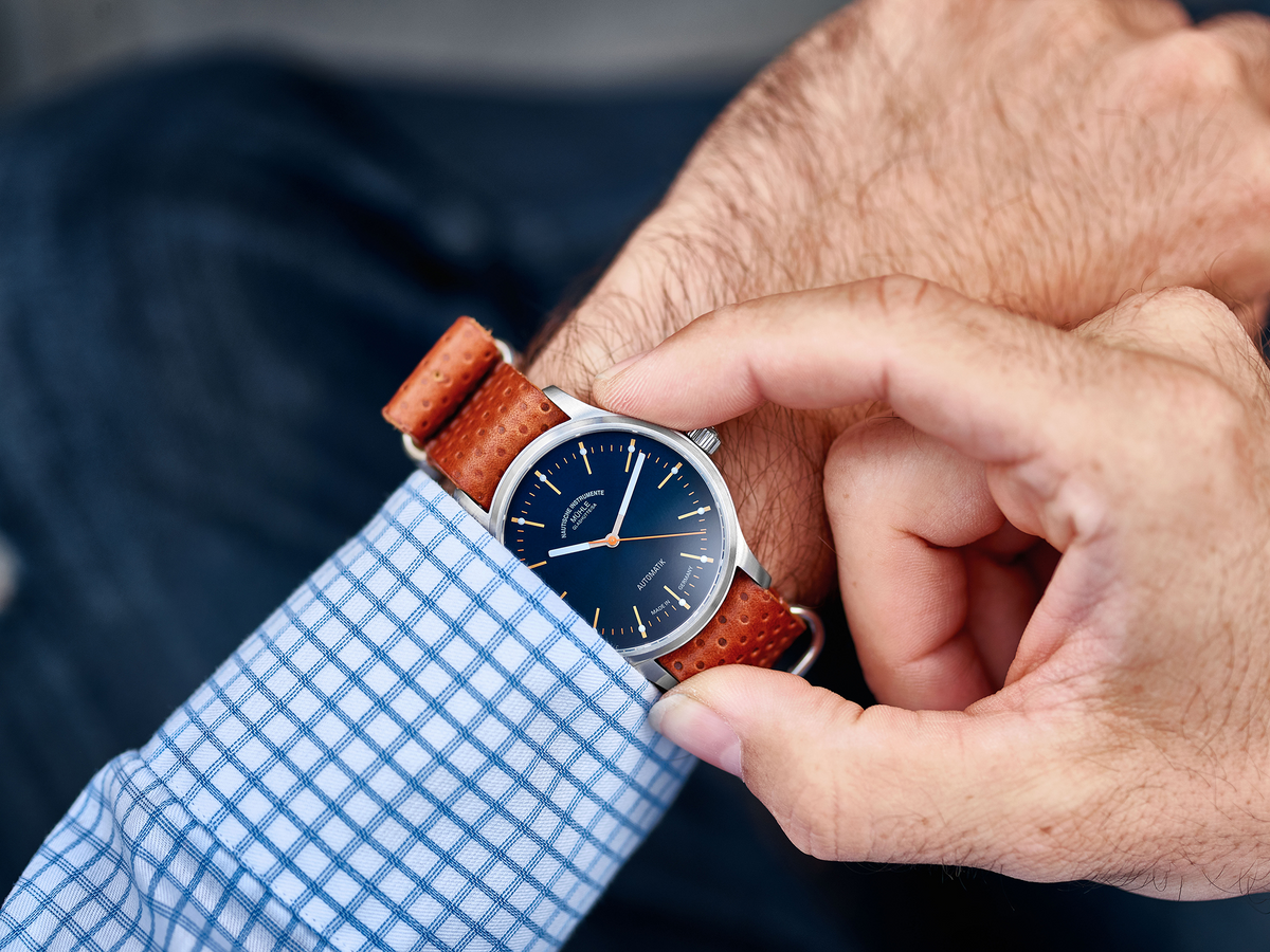 Mühle-Glashütte Panova Blue worn on the wrist with a checked shirt