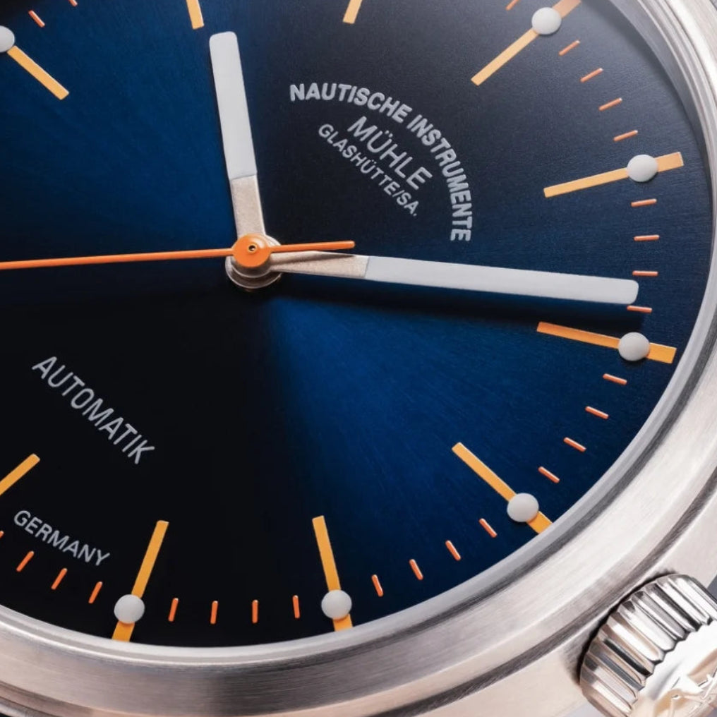 Mühle-Glashütte Panova Blue dial close-up with orange accents and luminous hour markers