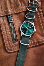 Mühle-Glashütte Panova Green on a brown leather jacket
