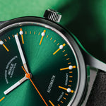 Mühle-Glashütte Panova Green dial close-up with orange accents and luminous hour markers