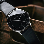 Sternglas Naos Automatic black on a wooden crate, angle view