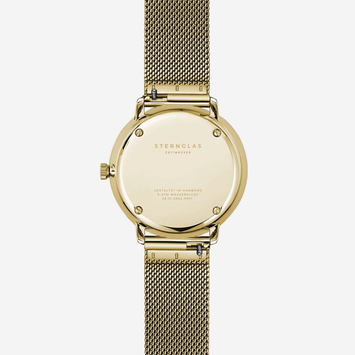 Case back of the Sternglas Naos XS gold-tone watch with quick-change mesh bracelet