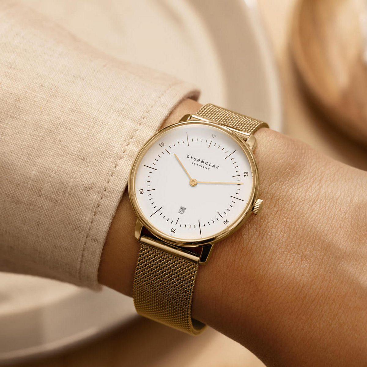 Sternglas Naos XS gold-tone women's watch worn on the wrist